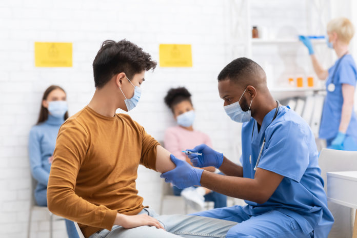 Coronavirus,Vaccination.,Doctor,Vaccinating,Asian,Male,Patient,Giving,Covid-19,Vaccine